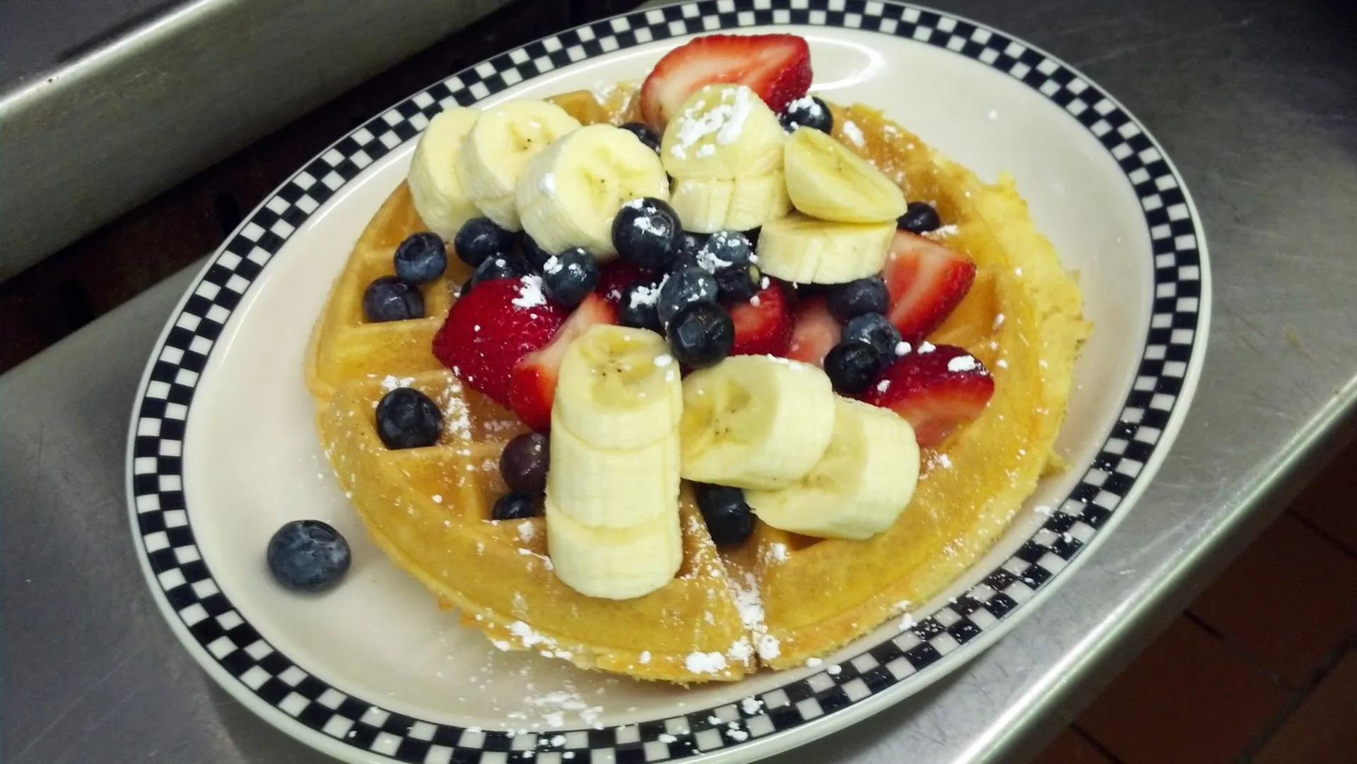 Silver Coin's waffle topped with strawberries, bananas and blueberries